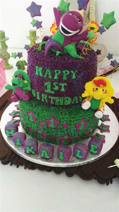 a birthday cake is decorated with purple and green frosting