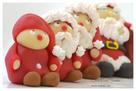 three red and white santa clause figurines sitting next to each other