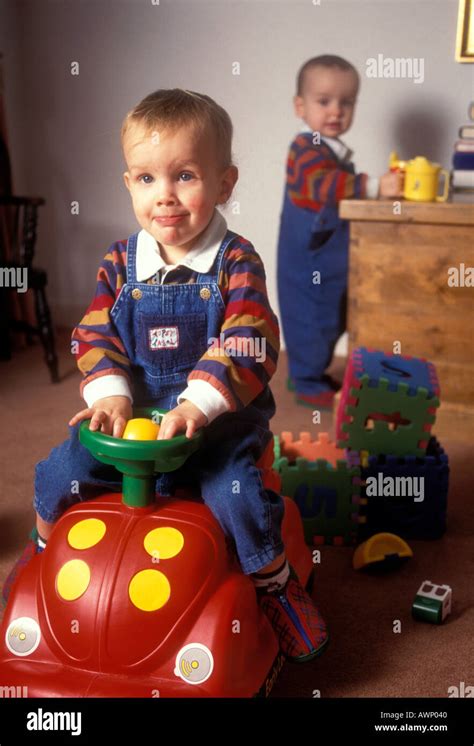 BOY SITTING ON TOY CAR Stock Photo - Alamy