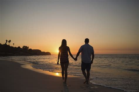 couple holding hands while walking on beach | Couple beach, Couple holding hands, Couple beach ...