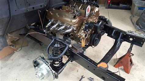 5.3L Vortec Engine painted gold & stainless headers sitting on custom motor mounts & original ...