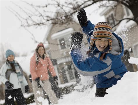 Three children having a snowball fight - Stock Image - F013/3823 - Science Photo Library