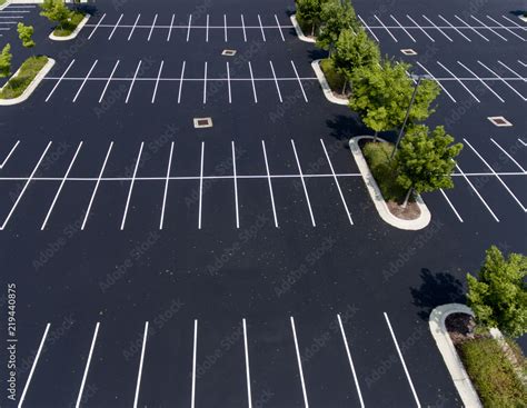 parking lot,asphalt,island,trees,stalls,parking stalls,paint,green Foto Stok | Adobe Stock