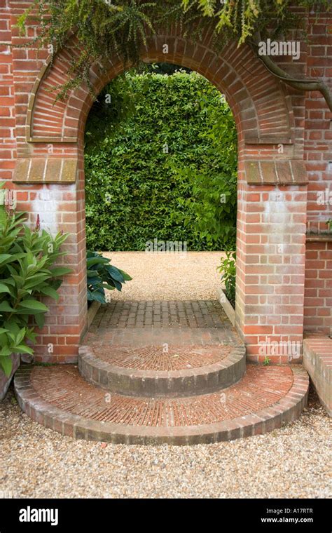 Brick Arch and Steps in Garden Wall Stock Photo - Alamy