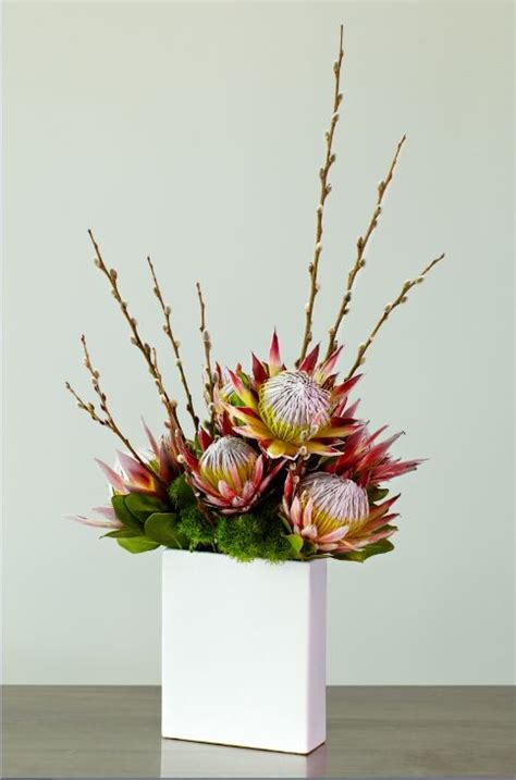 Modern King Protea Centerpiece www.tablescapesby… www.facebook.com ...