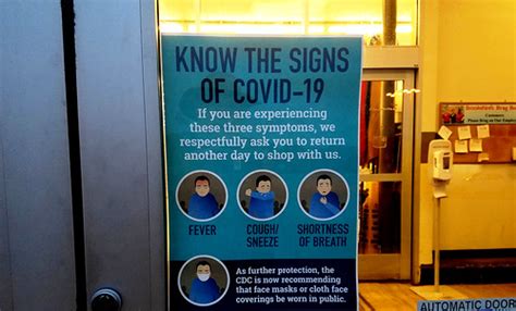 "Know the Signs of COVID-19": warning sign posted at the e… | Flickr