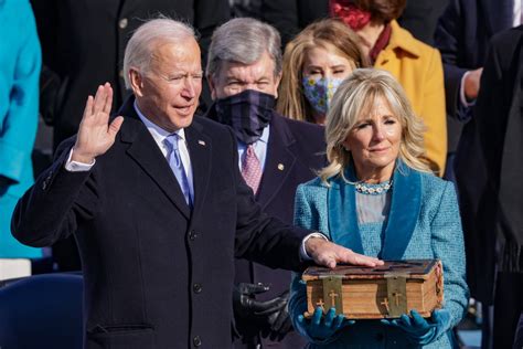 Biden takes the oath of office with troops on guard and towering ...