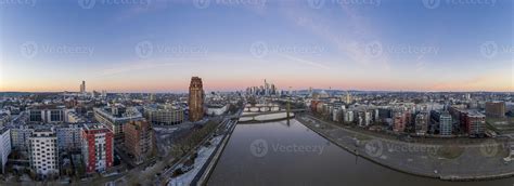 Aerial panoramic picture of Frankfurt skyline with river Main with colorful sky during sunrise ...