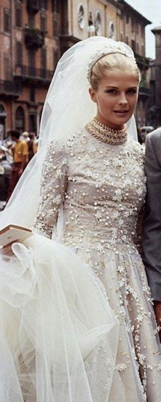 the bride and groom are walking down the street