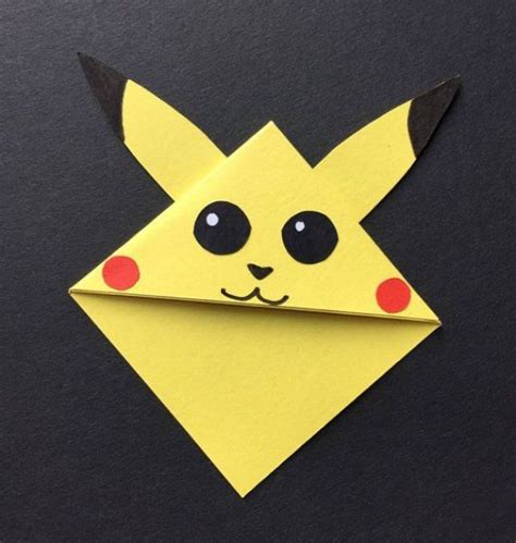 Pikachu pokemon corner bookmark made from card and paper. Shown on the corner of a book in the ...