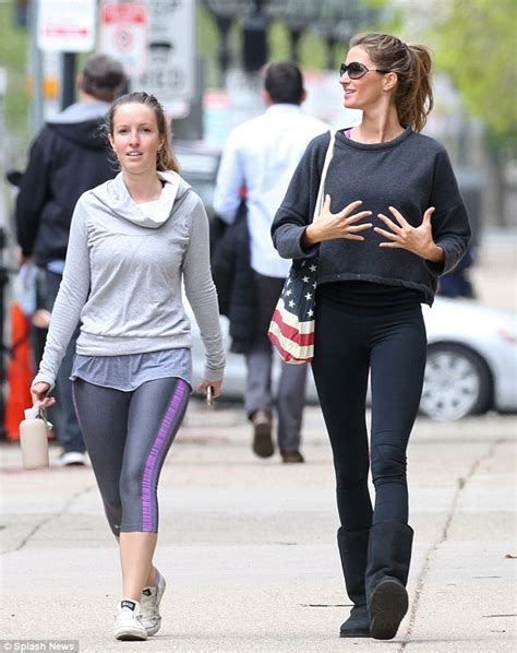 Gisele Bundchen puts her younger sister in a headlock as they lark around on a stroll through ...