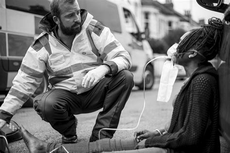 Male paramedic putting on an | Free Photo - rawpixel