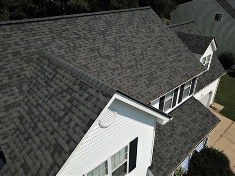 an aerial view of a house with gray shingles