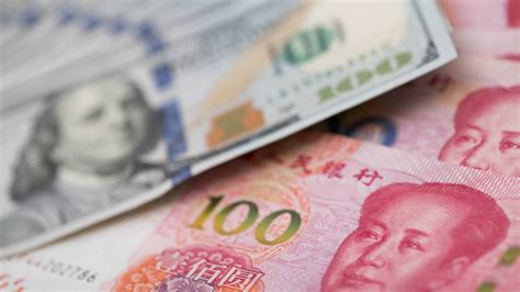 Dollar index holds near 3-week lows; yuan drops