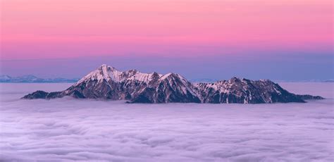 1366x768 wallpaper | snow covered rocky mountain above clouds | Peakpx