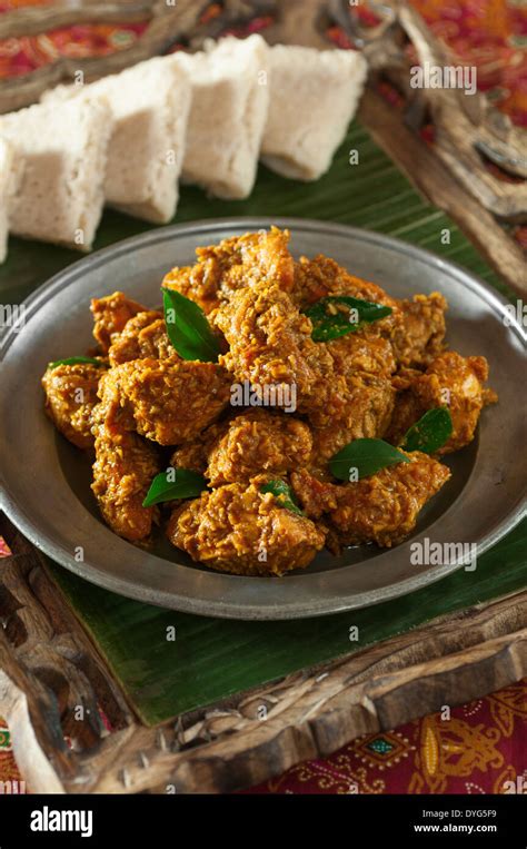 Chicken Sukka. Mangalore style dry coconut curry with neer dosas Stock Photo - Alamy