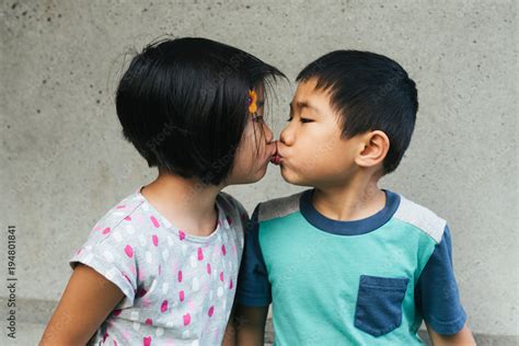 Boy girl fraternal twin young children kissing on the lips Stock Photo | Adobe Stock