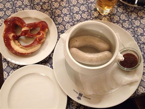 two plates with donuts on them next to a cup and saucer