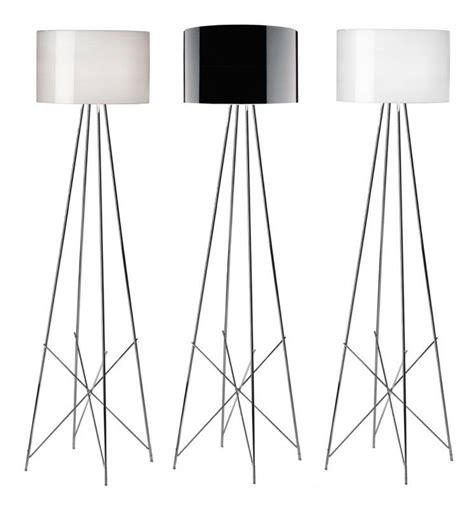 three black and white floor lamps sitting next to each other