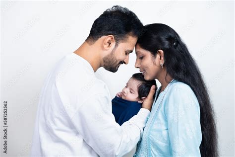 Portrait of Indian parents with newborn baby, Young asian couple ...