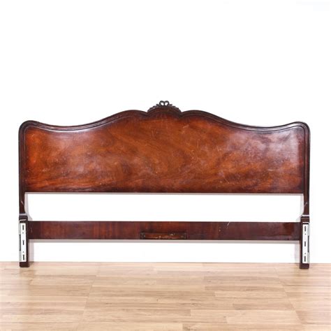 This headboard is featured in a solid wood with a glossy mahogany finish. This American ...