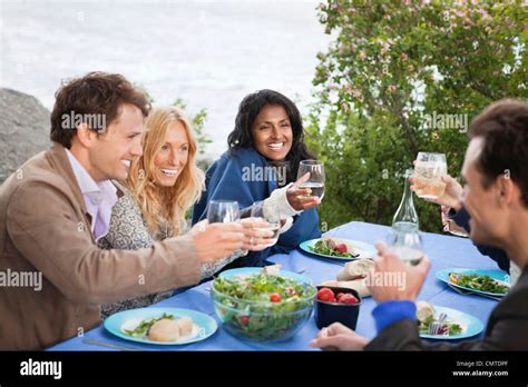 Friends toasting drink Stock Photo - Alamy