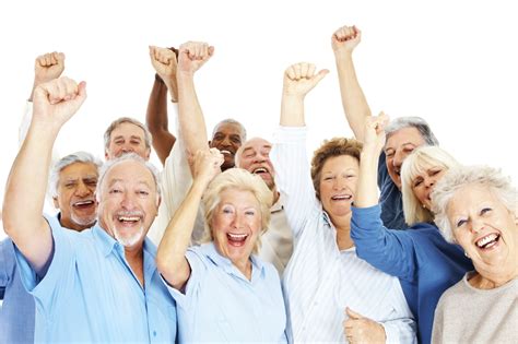 Group of happy senior citizens with their hands raised over white ...