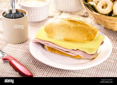 typical Brazilian snack, pão de sal with sliced mozzarella cheese and ...