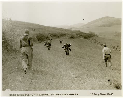 German soldiers surrender to 7th Infantry Division men in large field ...