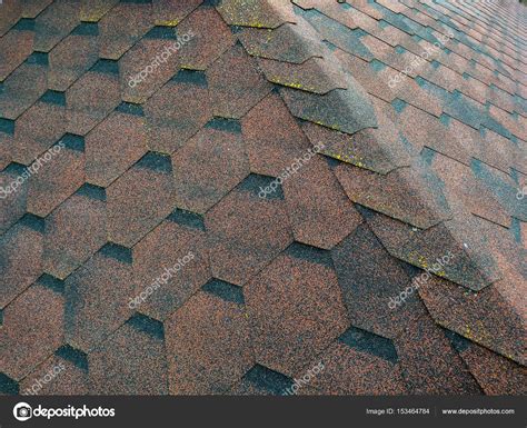 Roof with aged asphalt tiles — Stock Photo © PEPPERSMINT #153464784