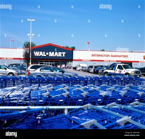 Walmart storefront exterior with blue shopping carts in the parking lot Canada KATHY DEWITT ...