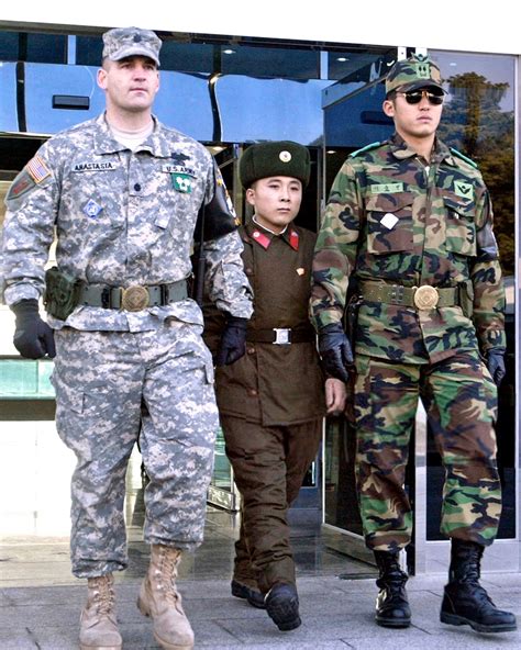 Repatriated North Korean soldier walking in between an American (1st ...