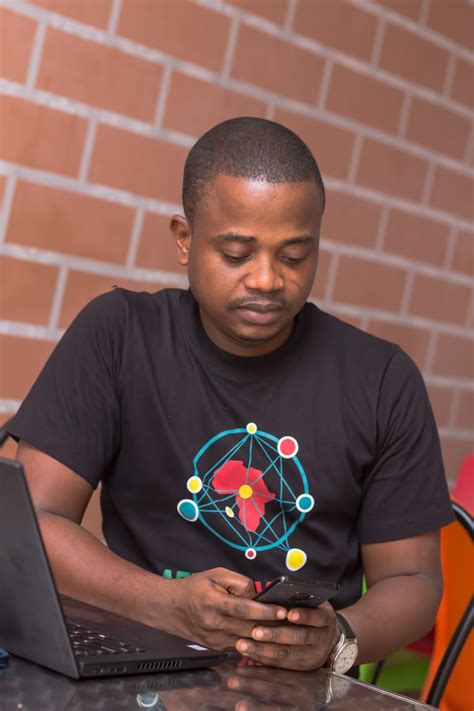 A Man Using a Smartphone Inside the Office · Free Stock Photo