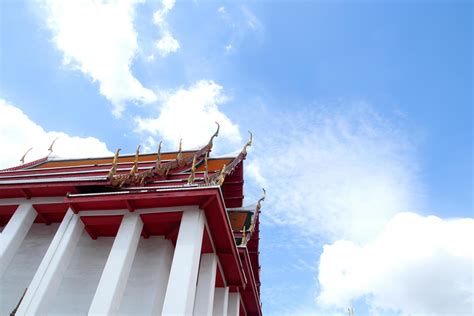 Beside white church with red triangle shape roof in Thai ancient style ...