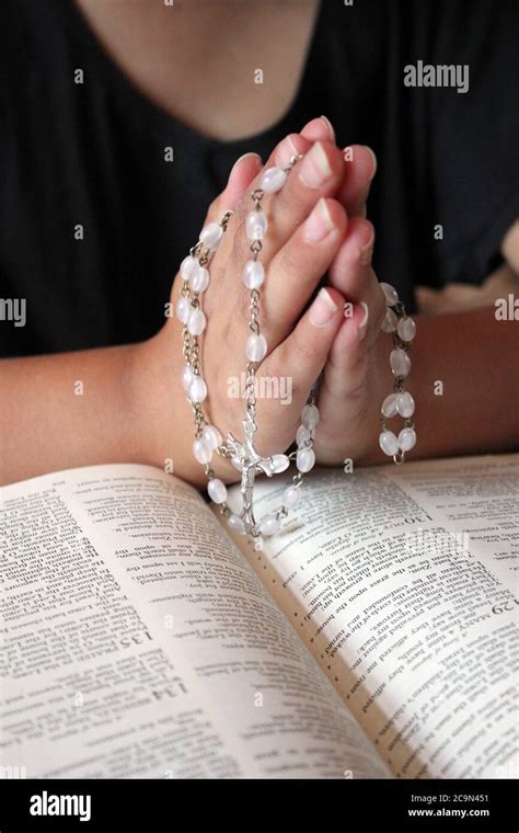 catholic praying hands with bible and rosary beads background with copy space Stock Photo - Alamy