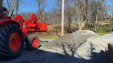 Kubota m5660 spreading 45ton of 2a mod stone - YouTube