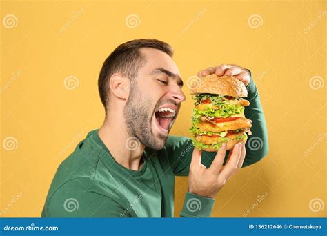 Young Hungry Man Eating Huge Burger Stock Photo - Image of cheese, caucasian: 136212646