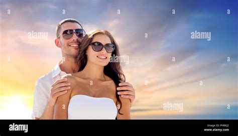 happy couple hugging over sunset sky background Stock Photo - Alamy