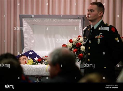 Mourners gather at the open casket of Army Pvt. David E. Dietrich ...