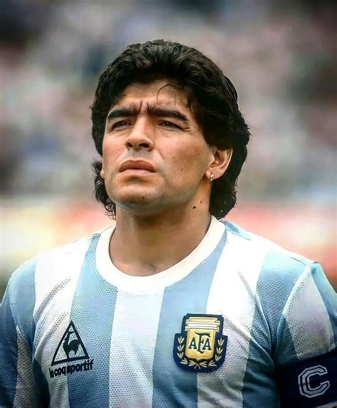 a close up of a soccer player wearing a blue and white striped shirt ...