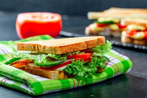 Sandwich with ham, cheese, tomatoes, lettuce, and toasted bread ...