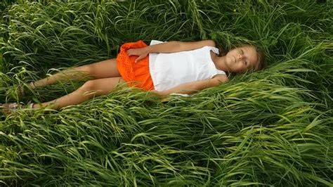 Little Girls Resting on the Green Grass. Beautiful Kids Lying on the Field, Stock Footage