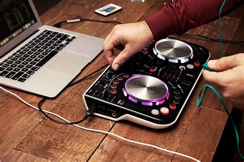 A photo of a DJ mixing on an entry-level controller.