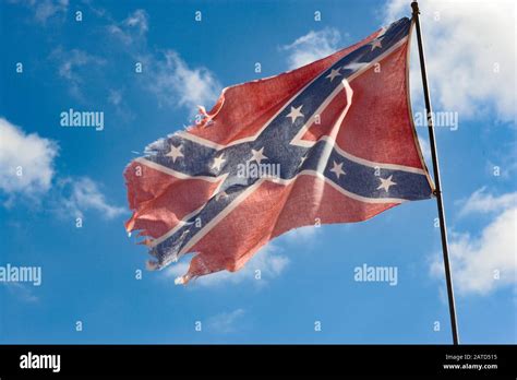 A wind-tattered Confederate flag flies over a trailer park is southwest ...