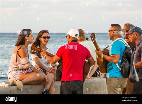 Musicians serenade tourists on the Malecon boardwalk in Havana, Cuba; Havana, Havana, Cuba Stock ...