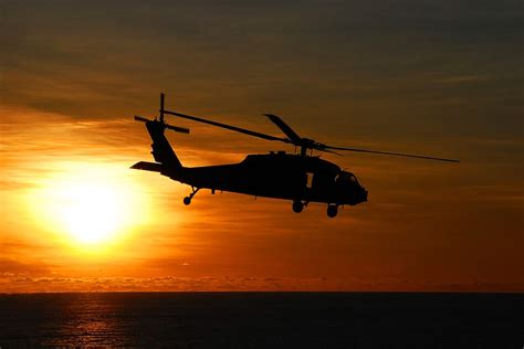 HD wallpaper: silhouette of helicopter, sea hawk helicopter, flying, sunset | Wallpaper Flare