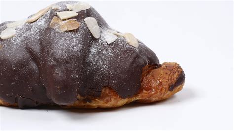 Almond and chocolate covered croissant pastry 13124774 Stock Video at Vecteezy