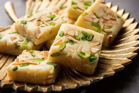 Milk powder barfi also known as Mava burfi, white Khoya burfi or Barfee, Indian Sweet food 2022