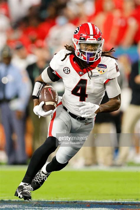 James Cook of the Georgia Bulldogs carries the ball in the first... | Georgia bulldogs, Georgia ...