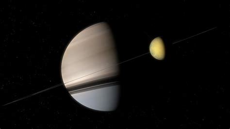 Titan With Saturn In The Distance Photograph by Mark Garlick/science Photo Library - Fine Art ...